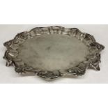 A Sterling silver circular card tray with scalloped edge on three feet, 324g, 22cm diam, by Lee &