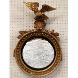 An antique Irish Style, gilt gesso convex circular wall mirror, with ball decoration beneath an