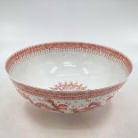 A large presentation Oriental porcelain bowl decorated with stylised dragon, red character marks
