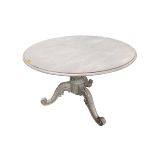 A Victorian circular grey painted dining table with carved pedestal trefoil base, scrolling feet,