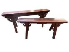 Two late C19th/early 20th Chinese hard wood benches, splayed legs with carved decorative supports,