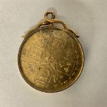 A George III 1787 gilt metal coin. Please note this coin is in a sealed yellow metal and glass mount