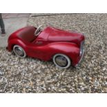 An original Austin J40 Pedal Car, finished in red with chrome fixtures and fittings, complete with