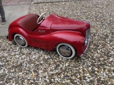 An original Austin J40 Pedal Car, finished in red with chrome fixtures and fittings, complete with