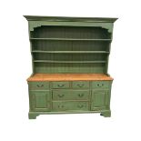 C20th green painted pine dresser with four short over 2 long drawers, flanked by two cupboards, on a