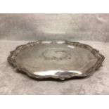 A Victorian Sterling silver circular tray, beaded scalloped edge central floral motif, 35cm diam, on