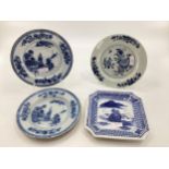 Four Oriental style blue and white plates