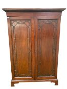 Late C19th/early C20th mahogany two door wardrobe with moulded cornice on a plinth base, opening