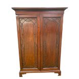 Late C19th/early C20th mahogany two door wardrobe with moulded cornice on a plinth base, opening