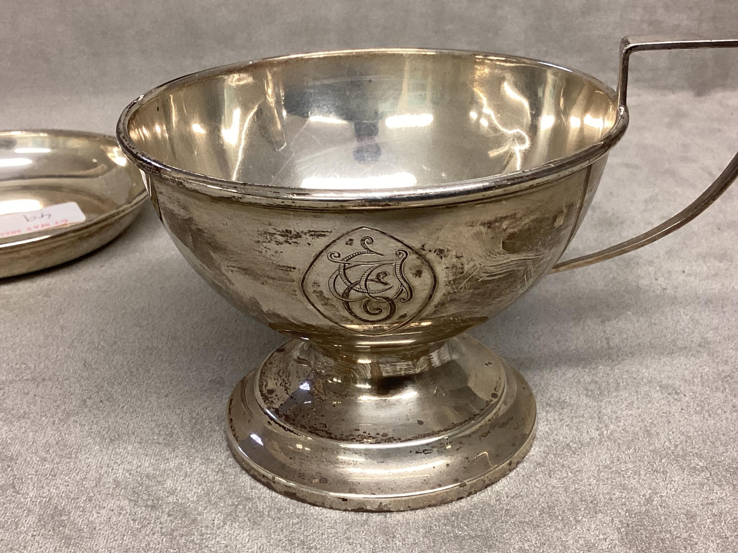 A Sterling silver cup, circular stepped base, loop handle, together with an unmarked white metal pin - Image 2 of 4