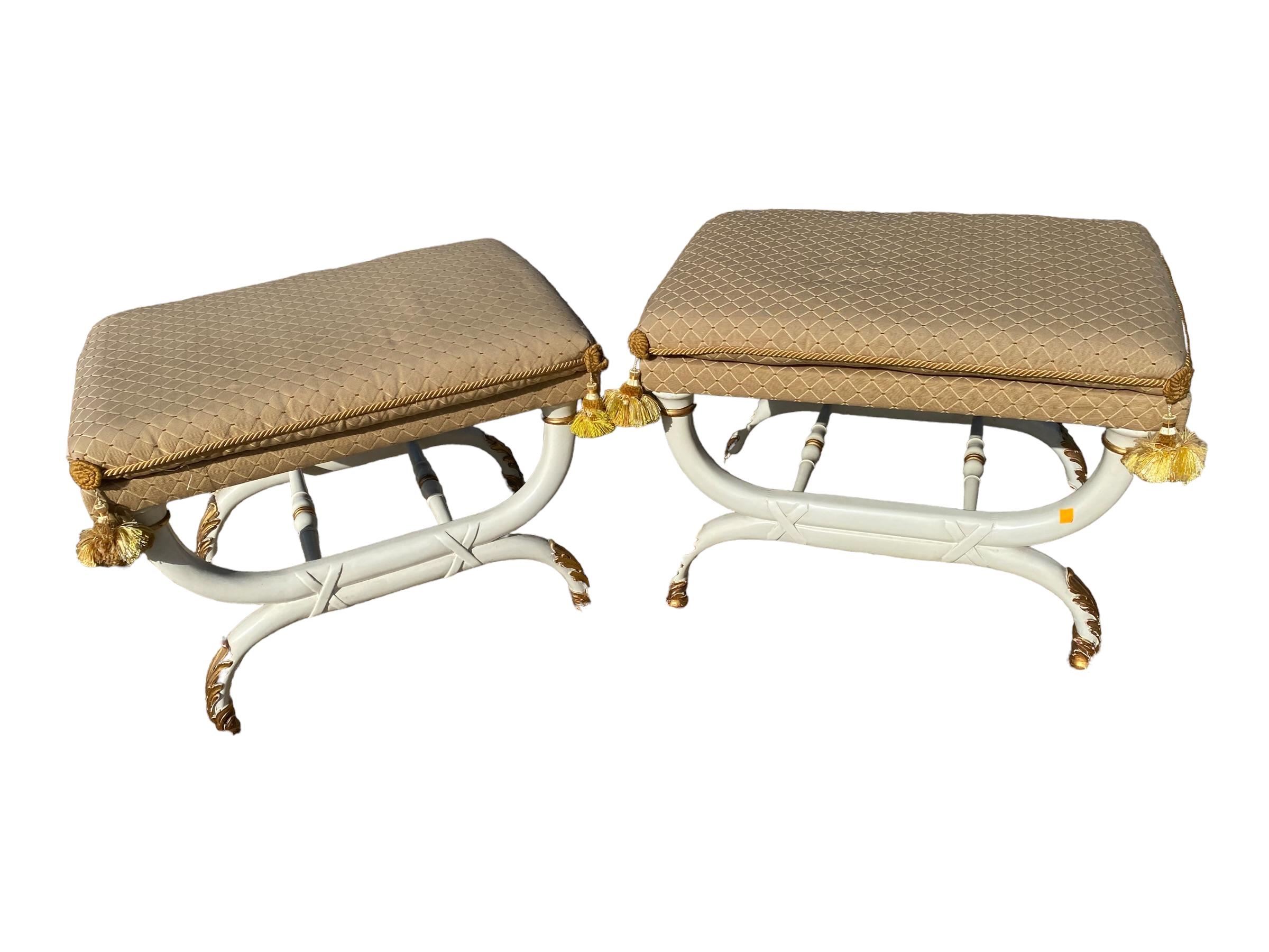 Pair of Regency style x framed upholstered stools, painted with gilt decoration with upholstered