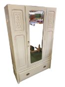 A C20th chalk painted wardrobe, central mirrored door, flanked by two cupboard doors, with single