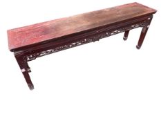 A C19th/20th Chinese low side table or bench with fretwork frieze (some losses), 155 x 33 x 55 cm