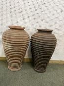 Two similar terracotta tall ribbed hoop pattern urns/pots, 65cm H