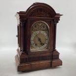 C19th Oak cased mantle clock of large proportions, arched dial with silver chapter ring, gilt