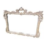 A modern wall mirror, with decorative frame of scrolling foliage, 86H x 109W cm