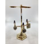 An Edwardian brass free standing three bottle spirit dispenser by Gaskell and chambers, optic