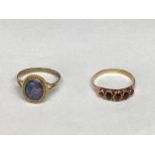A 9ct gold and black opal ring, oval black opal doublet in a bezel setting together with an unmarked