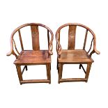 A pair of C19th style Chinese hardwood horse shoe arm chairs, S-shaped slat back with carved