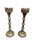 Pair of tall weathered candle stands with Pineapple Finials, on tripod feet; and a pair of