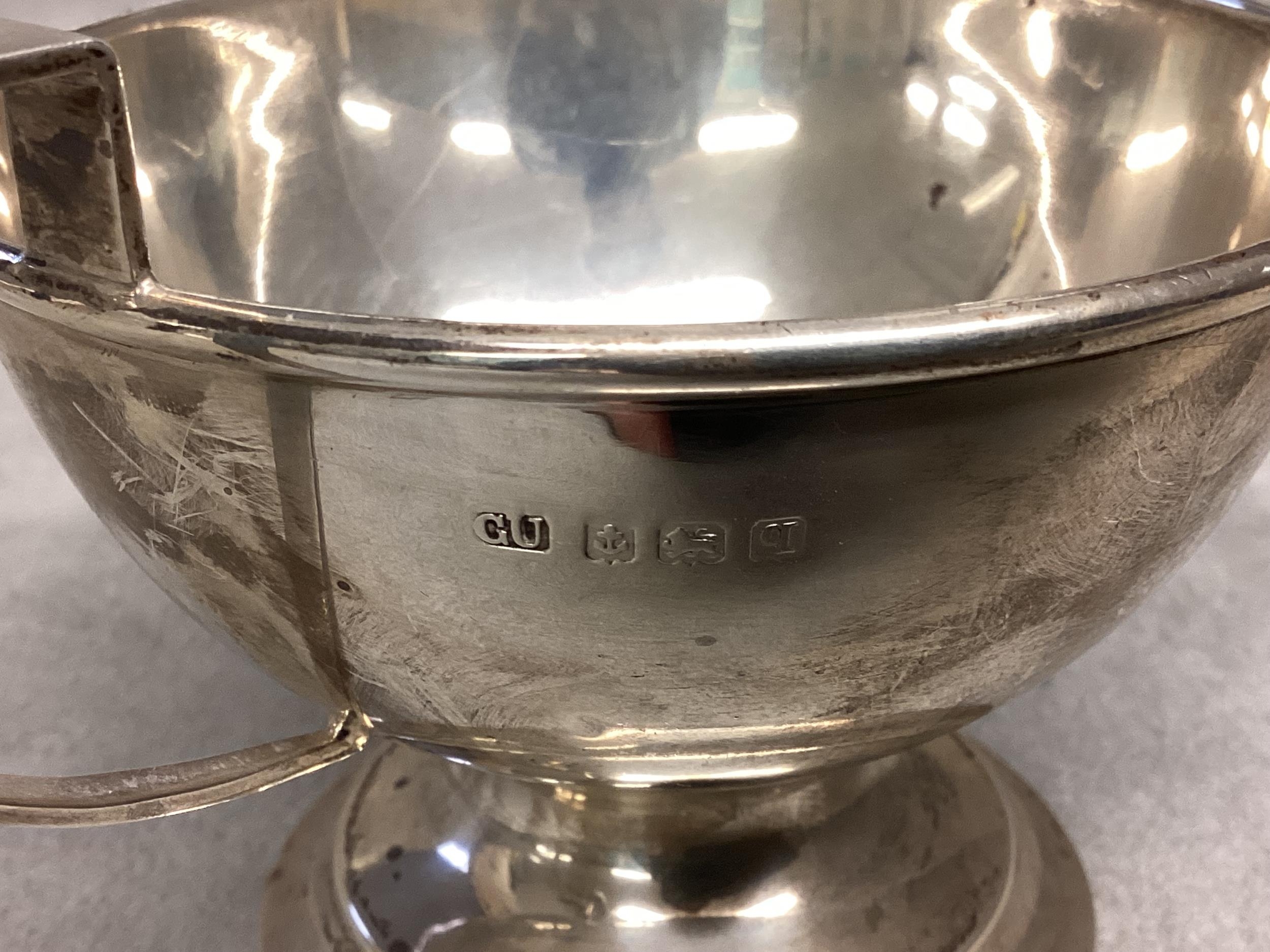 A Sterling silver cup, circular stepped base, loop handle, together with an unmarked white metal pin - Image 3 of 4