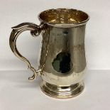 A Sterling silver mug, scroll handle on circular foot by Deakin and Francis, Birmingham, 1942. 378g