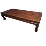 A large Oriental low table on four carved stylised feet, 200 x 91 x 50cm