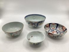 Four oriental style bowls of different designs, one with four character mark within double blue