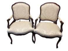 A good pair of traditional French style open arm chairs on cabriole legs with cream upholstery