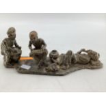 An African hardstone figural group, indistinctly signed and dated to base, 39 x 14 x 11cm