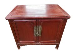 A C19th Style Chinese style red lacquered two door wedding cabinet, on square legs, light water