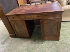 Victorian mahogany twin pedestal desk, the sides opening to reveal fitted drawers , and a worn red
