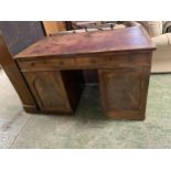 Victorian mahogany twin pedestal desk, the sides opening to reveal fitted drawers , and a worn red