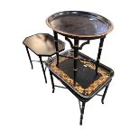 Three decorative black and gilt tables with tray to top (one fixed top, two with loose tray tops)