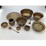 A collection of brass ware to include Oriental style charger, bowls etc.