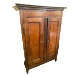 A Continental fruit wood Armoire, on raised legs with two doors and drawers and shelves to interior,