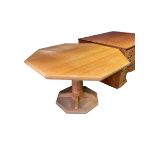 A wooden hexagonal kitchen pedestal table, some wear and fading