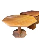 A wooden hexagonal kitchen pedestal table, some wear and fading