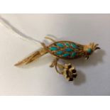 A marked yellow 18ct gold and turquoise set parrot brooch in a chinese style. 6.38g.