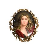 A Mourning pendant/Brooch central oval porcelain plaque with pierced unmarked yellow metal