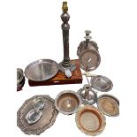 A collection of silver plate to include a column lamp, go to bed , wine coasters etc.