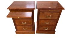 A pair of walnut veneered filing cabinets with brass handles, and brushing slide / bed side