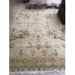 RUG: all over cream/yellow ground, with terracotta and light green stylized patterns, 391cm x 302cm,