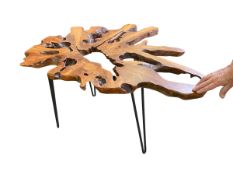 An unusual contemporary burr wood table on metal supports, no glass