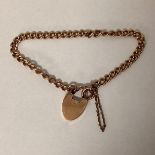A 9cT gold curb link rose gold bracelet with a 15ct gold heart shaped clasp. 19cm. 13.5g