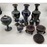A good quantity of Cloisonne vases, including a matched pair of baluster vases, on hardwood