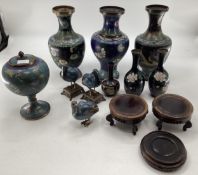 A good quantity of Cloisonne vases, including a matched pair of baluster vases, on hardwood