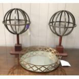 Pair of decorative metal globes on leather bases, and a decorative circular mirrored tray with brass