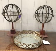 Pair of decorative metal globes on leather bases, and a decorative circular mirrored tray with brass