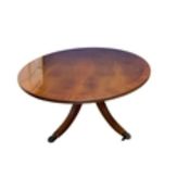 An oval coffee/centre table, modern reproduction on 4 out swept legs to brass castors,
